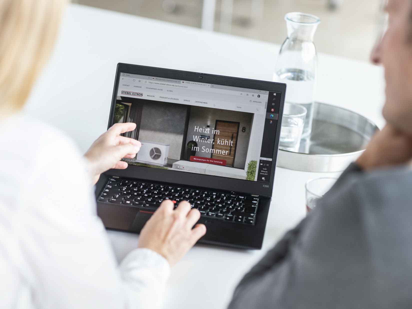 Frau guckt auf ihrem Laptop die STIEBEL ELTRON Website an