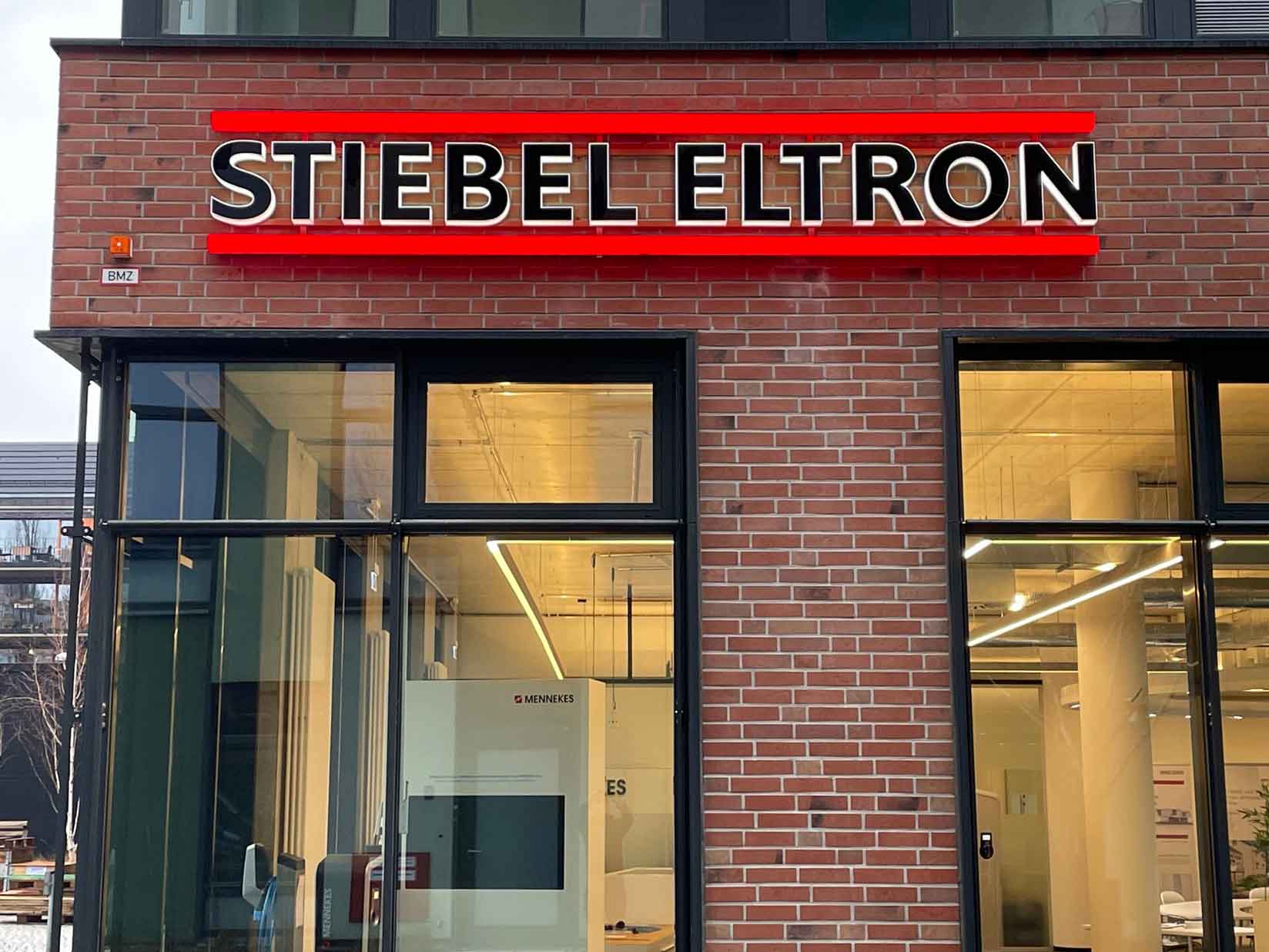 Leuchtlogo an einer Hauswand